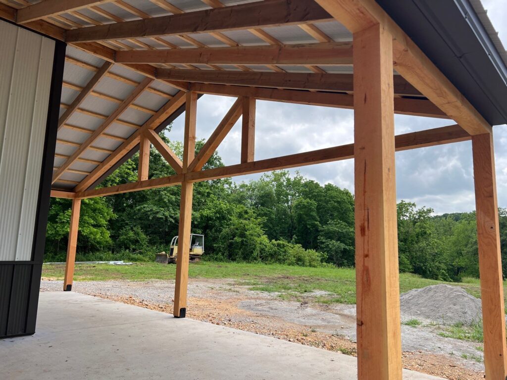 a post and beam timber framed porch on the front of a shop house
