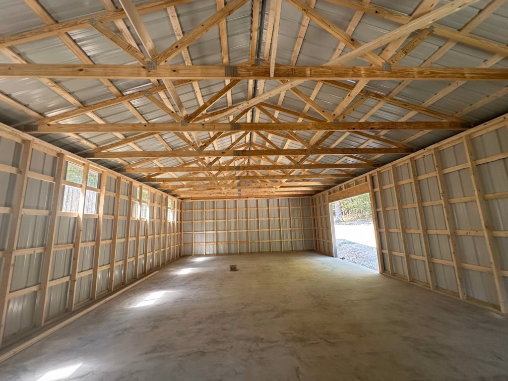 inside view of a stud-framed shop with garage door in northwest arkansas